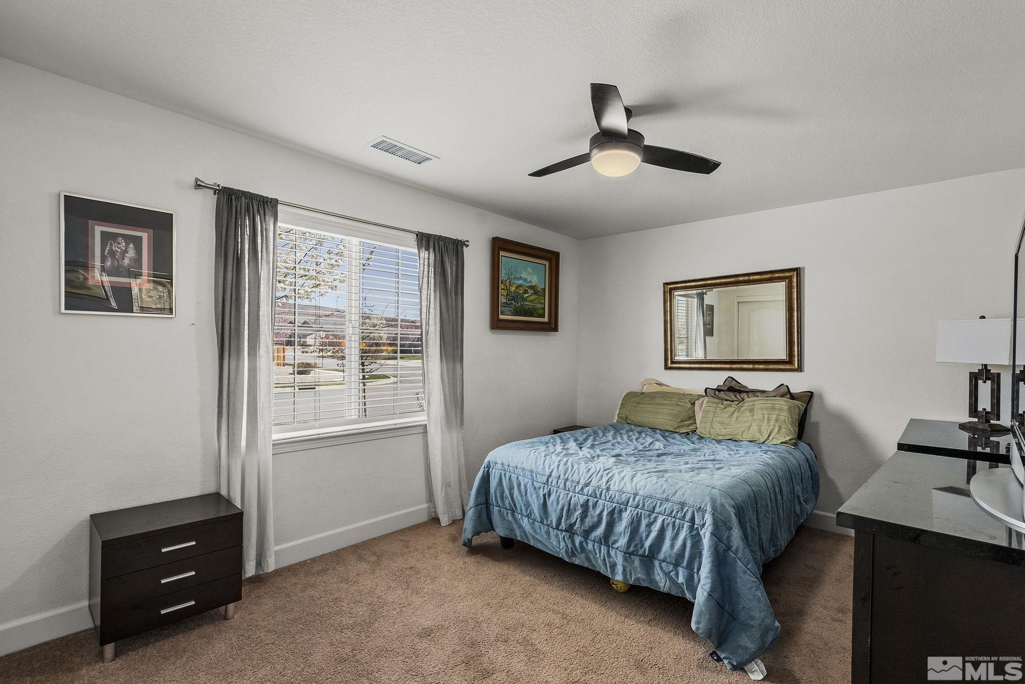 7707 Rhythm Circle Sparks, NV 89436 - Photo 16 of 25 a bedroom with a bed and a tv