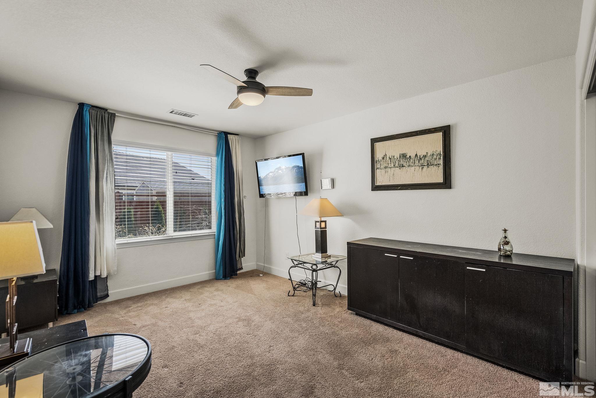 7707 Rhythm Circle Sparks, NV 89436 - Photo 18 of 25 a living room with furniture and a flat screen tv