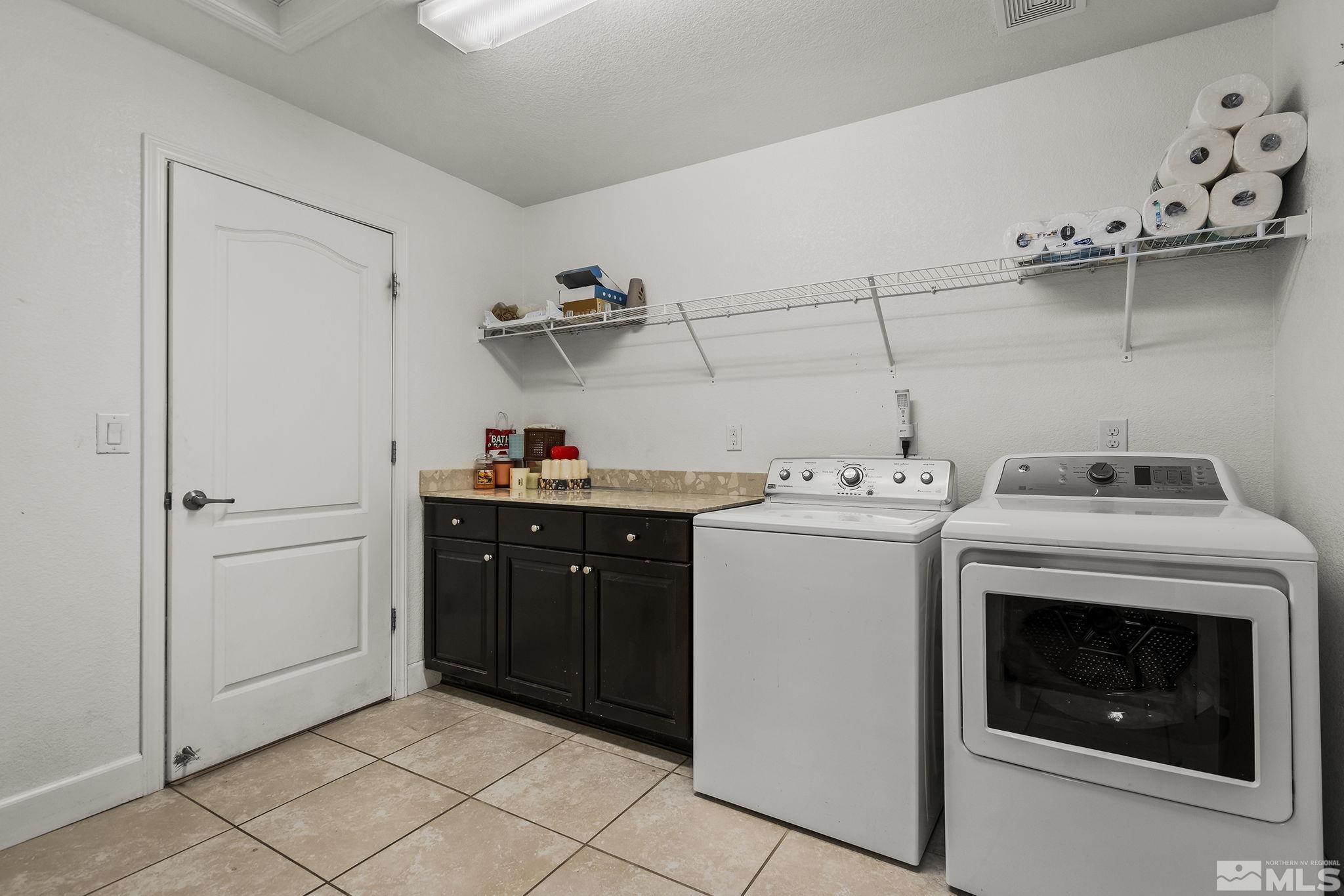 7707 Rhythm Circle Sparks, NV 89436 - Photo 19 of 25 a utility room with sink dryer and washer