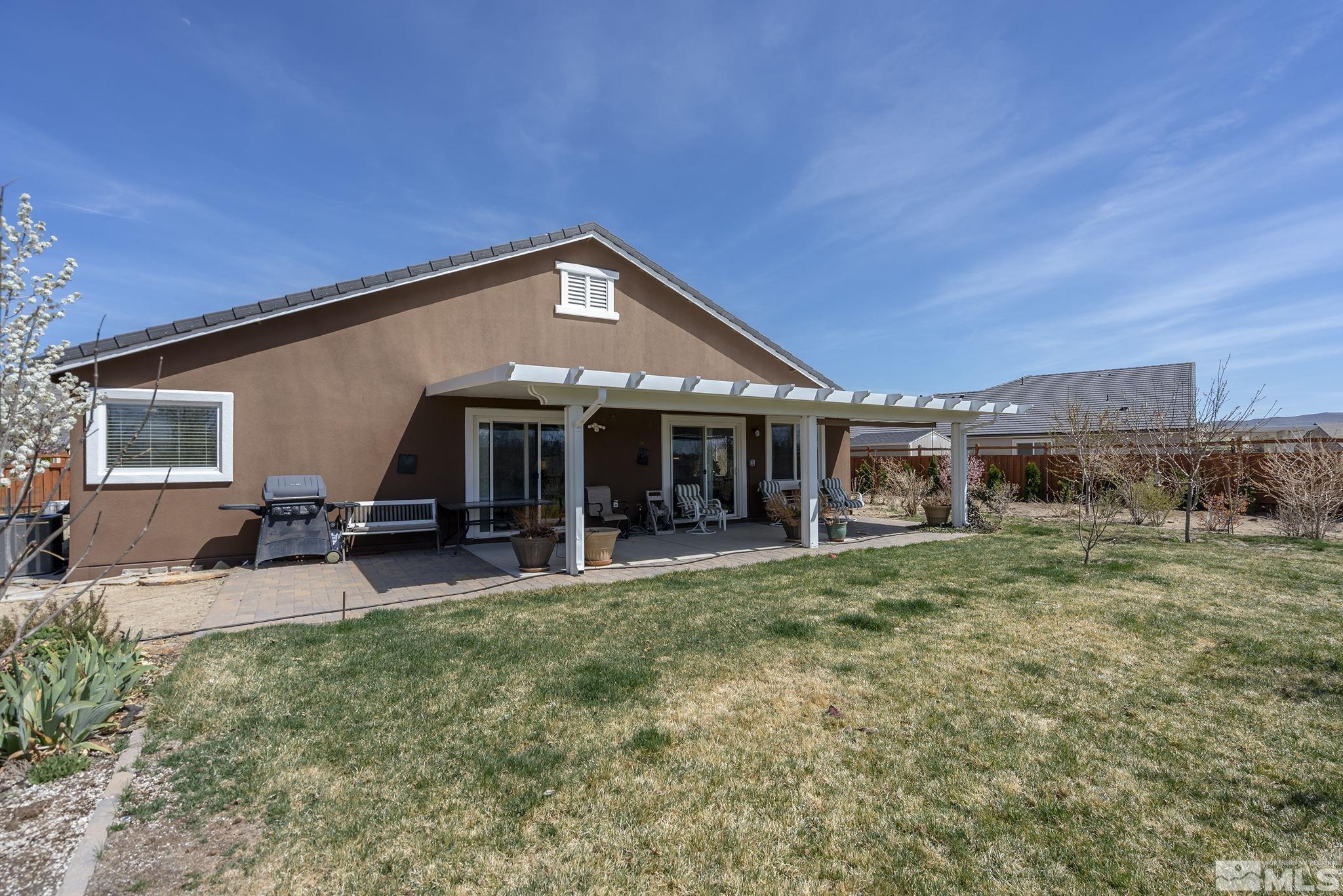 7707 Rhythm Circle Sparks, NV 89436 - Photo 20 of 25 a view of a house with a yard porch and sitting area