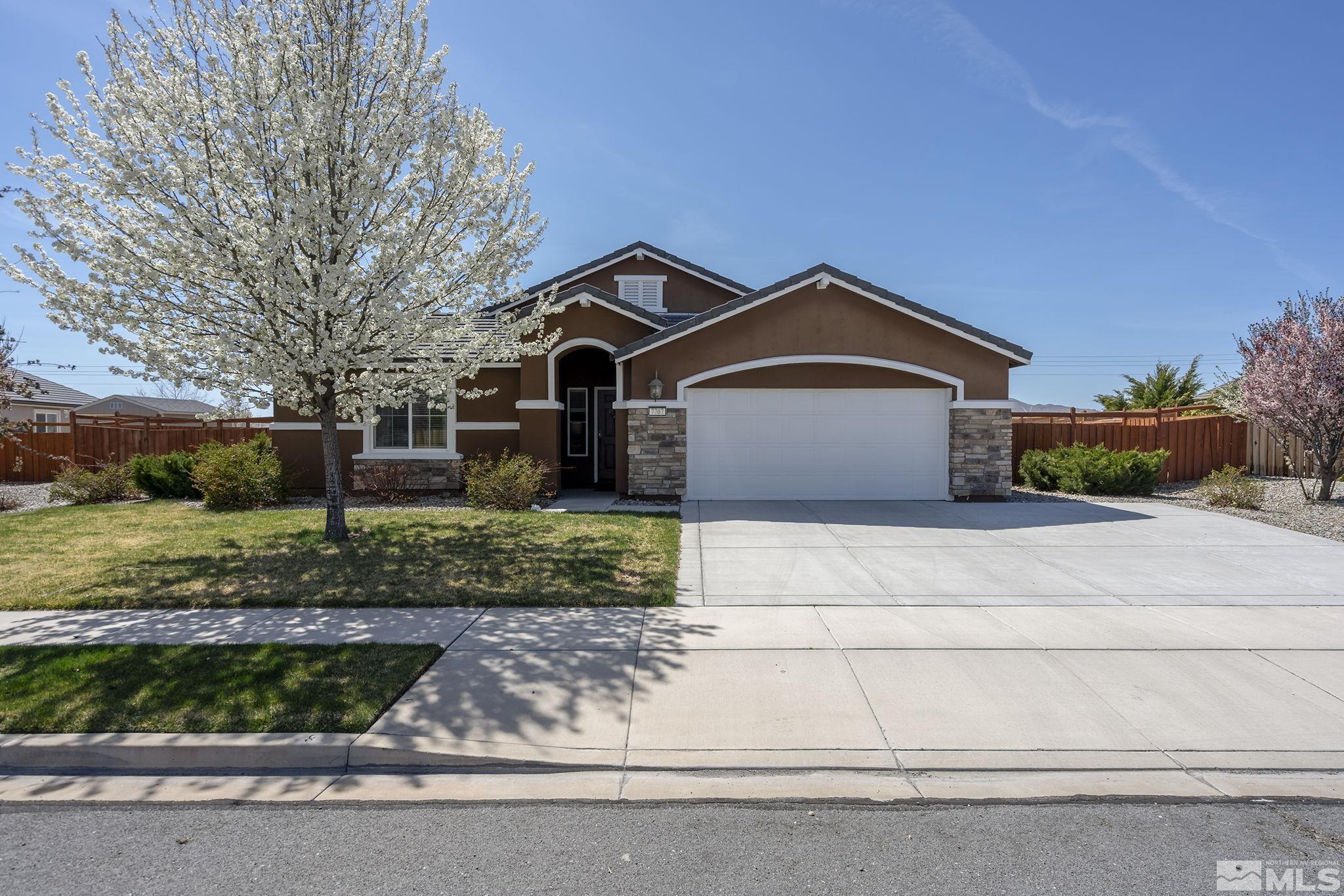 7707 Rhythm Circle Sparks, NV 89436 - Photo 2 of 25 a front view of a house with a yard and garage