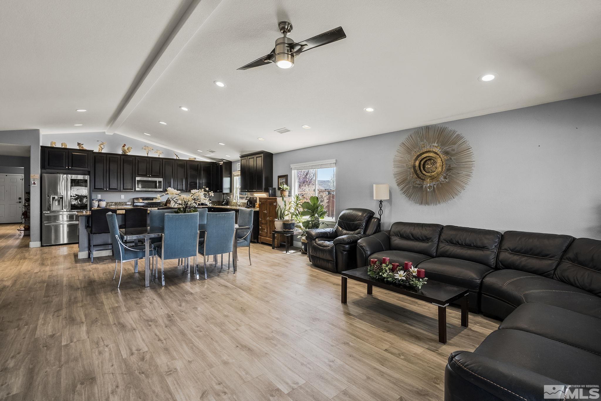 7707 Rhythm Circle Sparks, NV 89436 - Photo 7 of 25 a living room with lots of furniture and kitchen view