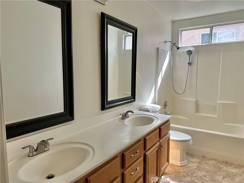 33722 Abbey Road Temecula, CA 92592 - Photo 26 of 44 a bathroom with a granite countertop sink toilet and shower