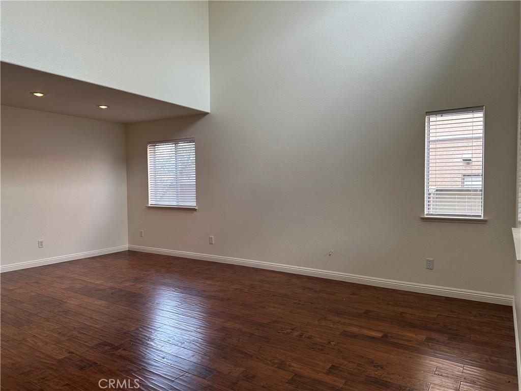 33722 Abbey Road Temecula, CA 92592 - Photo 5 of 44 an empty room with wooden floor and windows