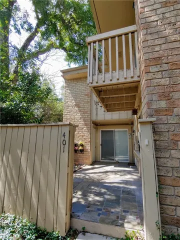 a view of house with backyard and wooden fence