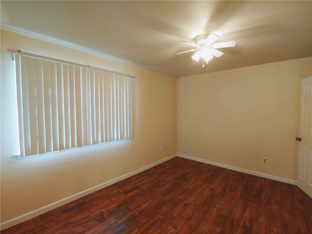 8340 Fathom Circle, Unit 401D Austin, TX 78750 - Photo 12 of 16 a view of an empty room with wooden floor and a window