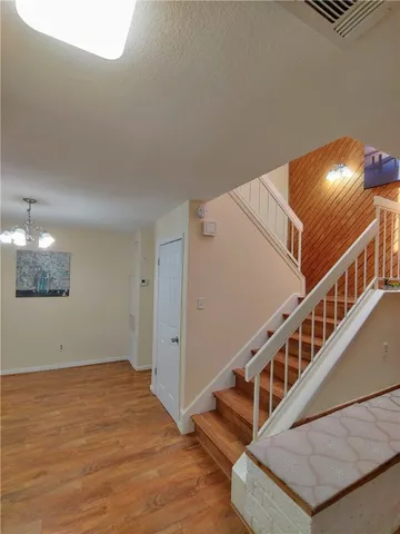 a view of an entryway with wooden floor