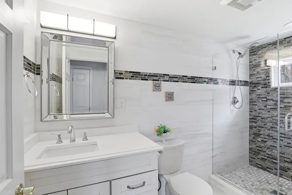 a bathroom with a sink toilet and shower