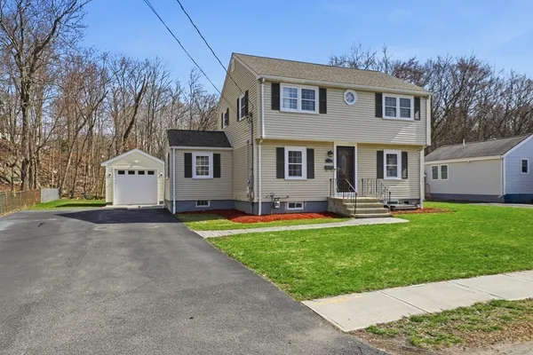 a front view of a house with a yard and garage