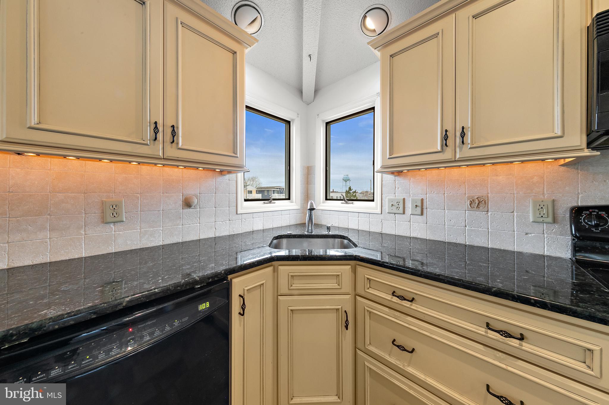 20 East 8th Street Barnegat Light, NJ 08006 - Photo 20 of 80 a kitchen with stainless steel appliances granite countertop a sink a stove and cabinets