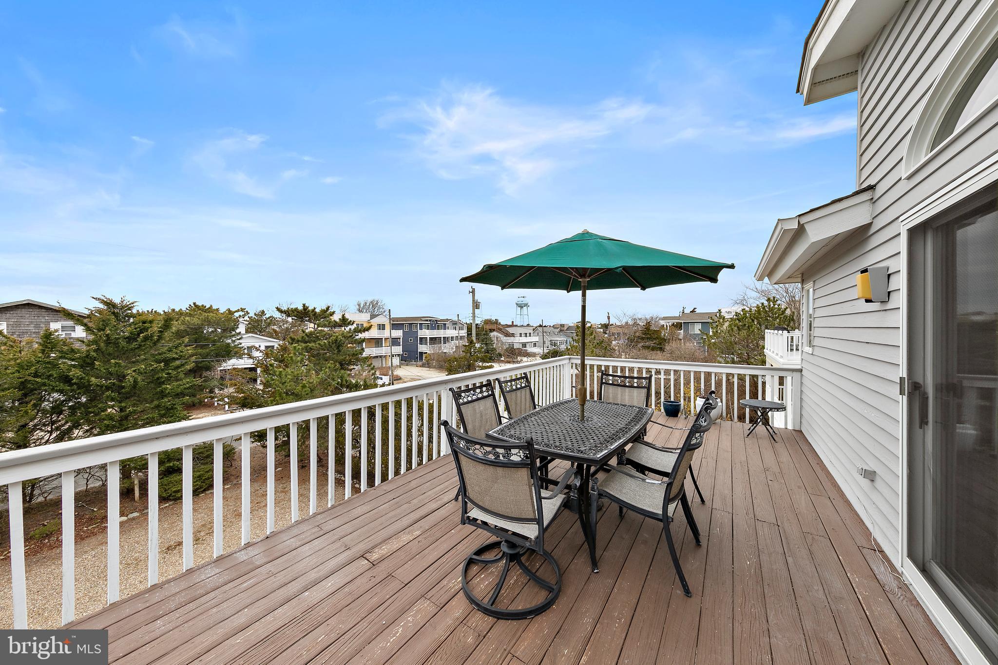 20 East 8th Street Barnegat Light, NJ 08006 - Photo 27 of 80 a view of a chairs and table on the wooden deck