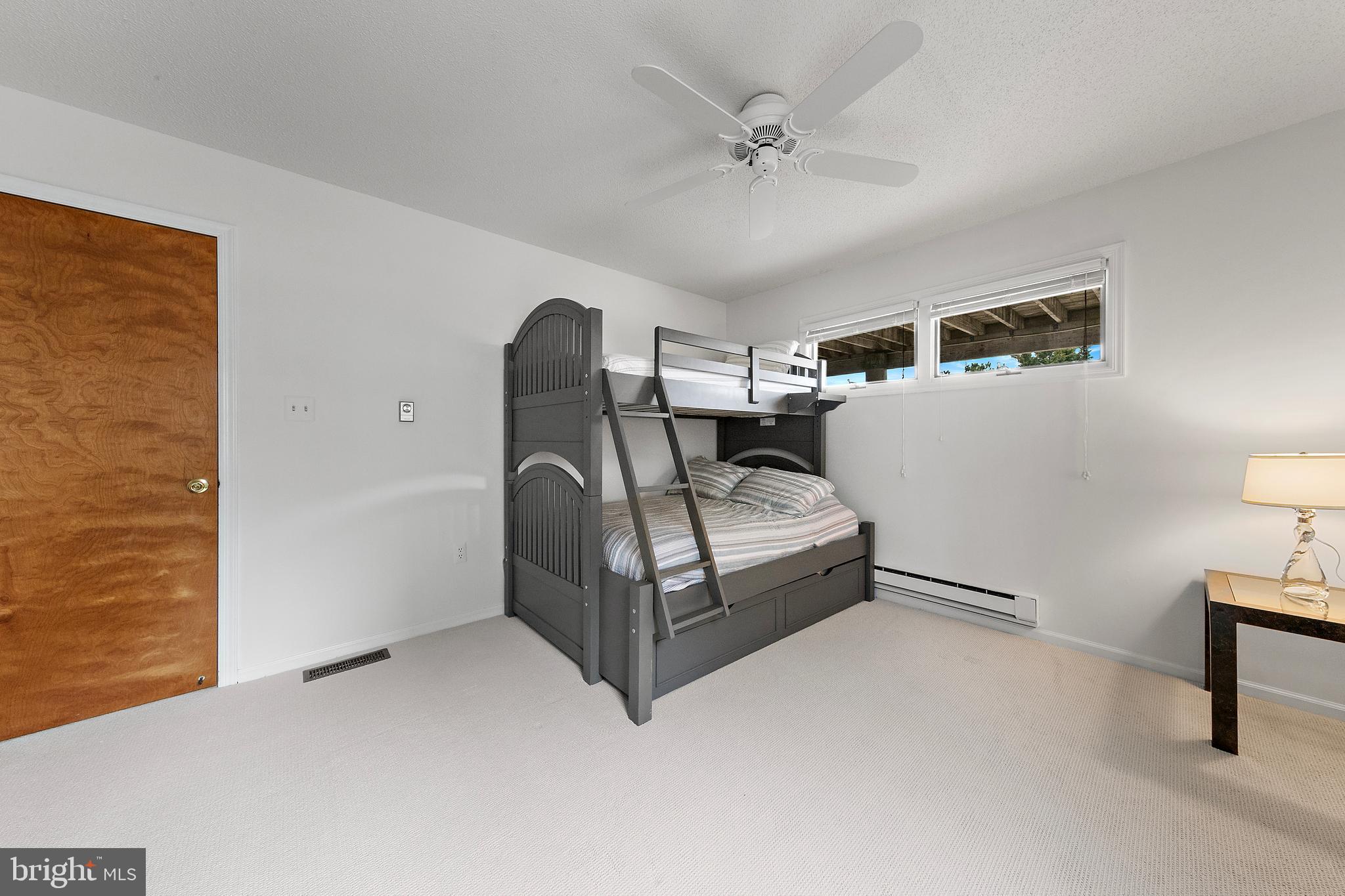 20 East 8th Street Barnegat Light, NJ 08006 - Photo 42 of 80 a bedroom with a bed and a lamp with the wooden floor
