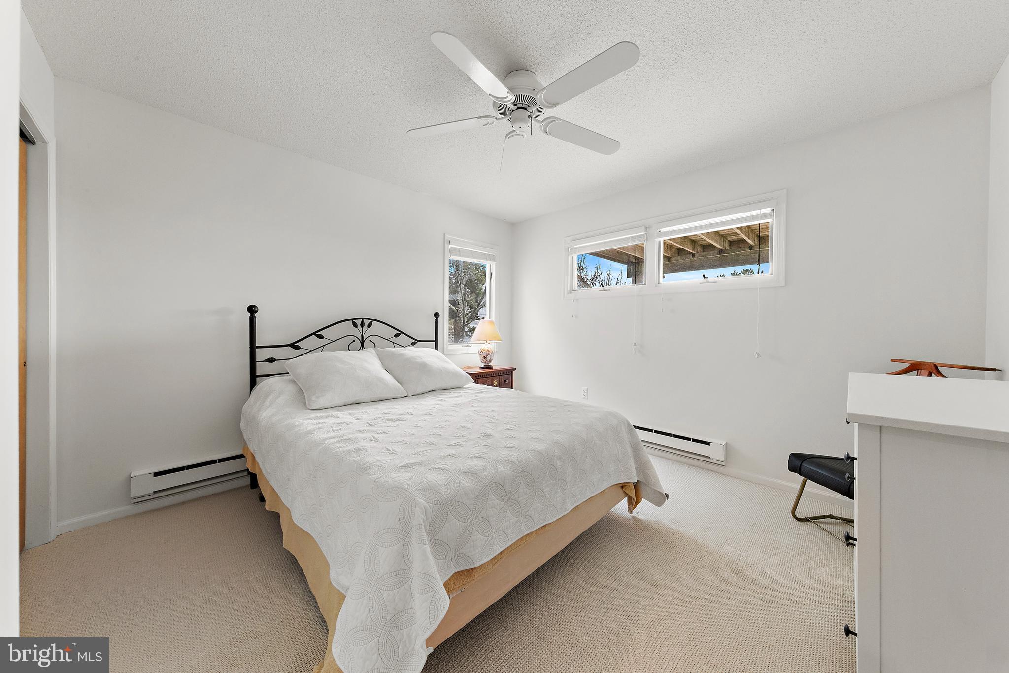 20 East 8th Street Barnegat Light, NJ 08006 - Photo 44 of 80 a bedroom with a bed and a ceiling fan