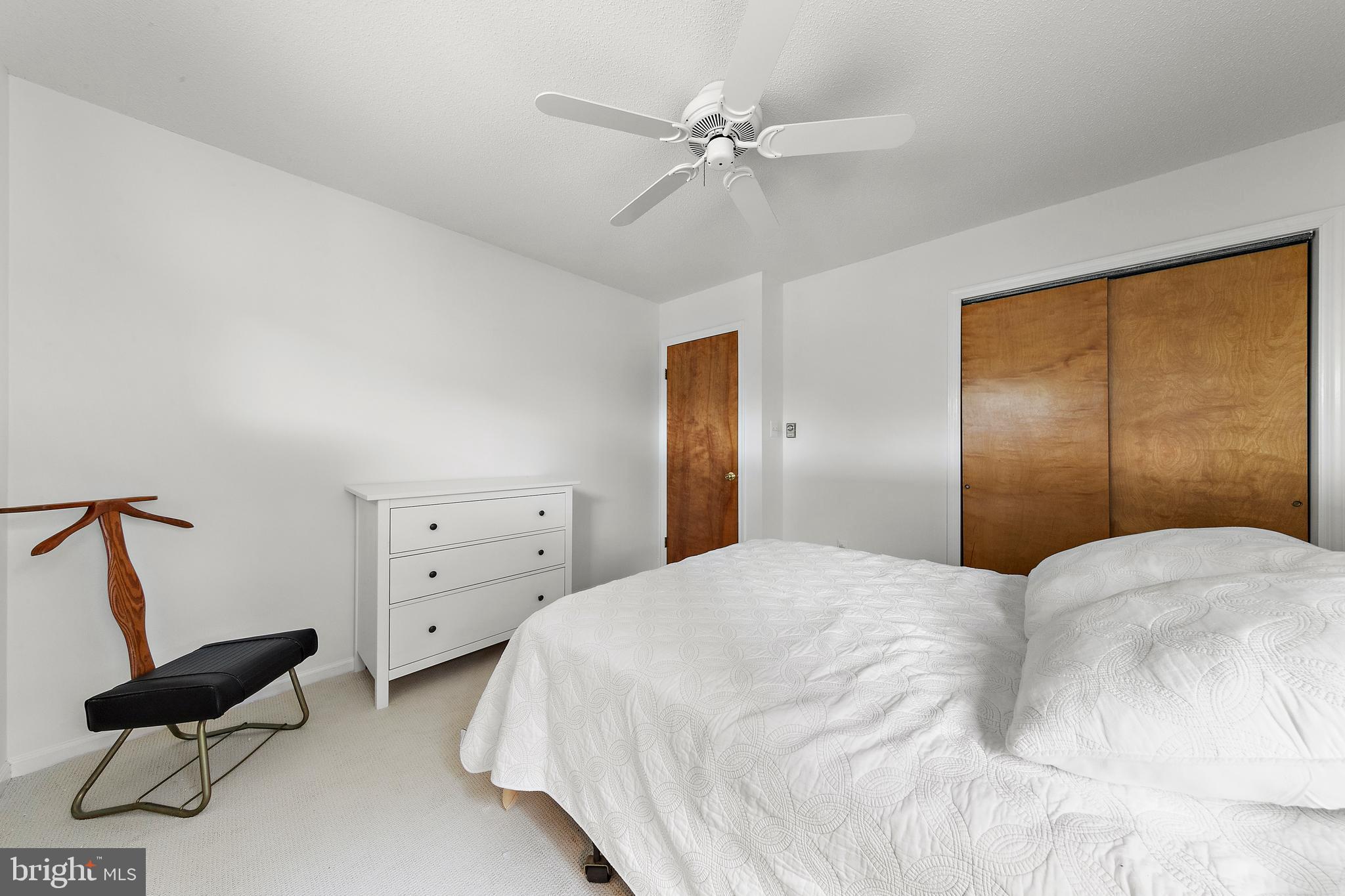20 East 8th Street Barnegat Light, NJ 08006 - Photo 45 of 80 a bedroom with a bed and a ceiling fan