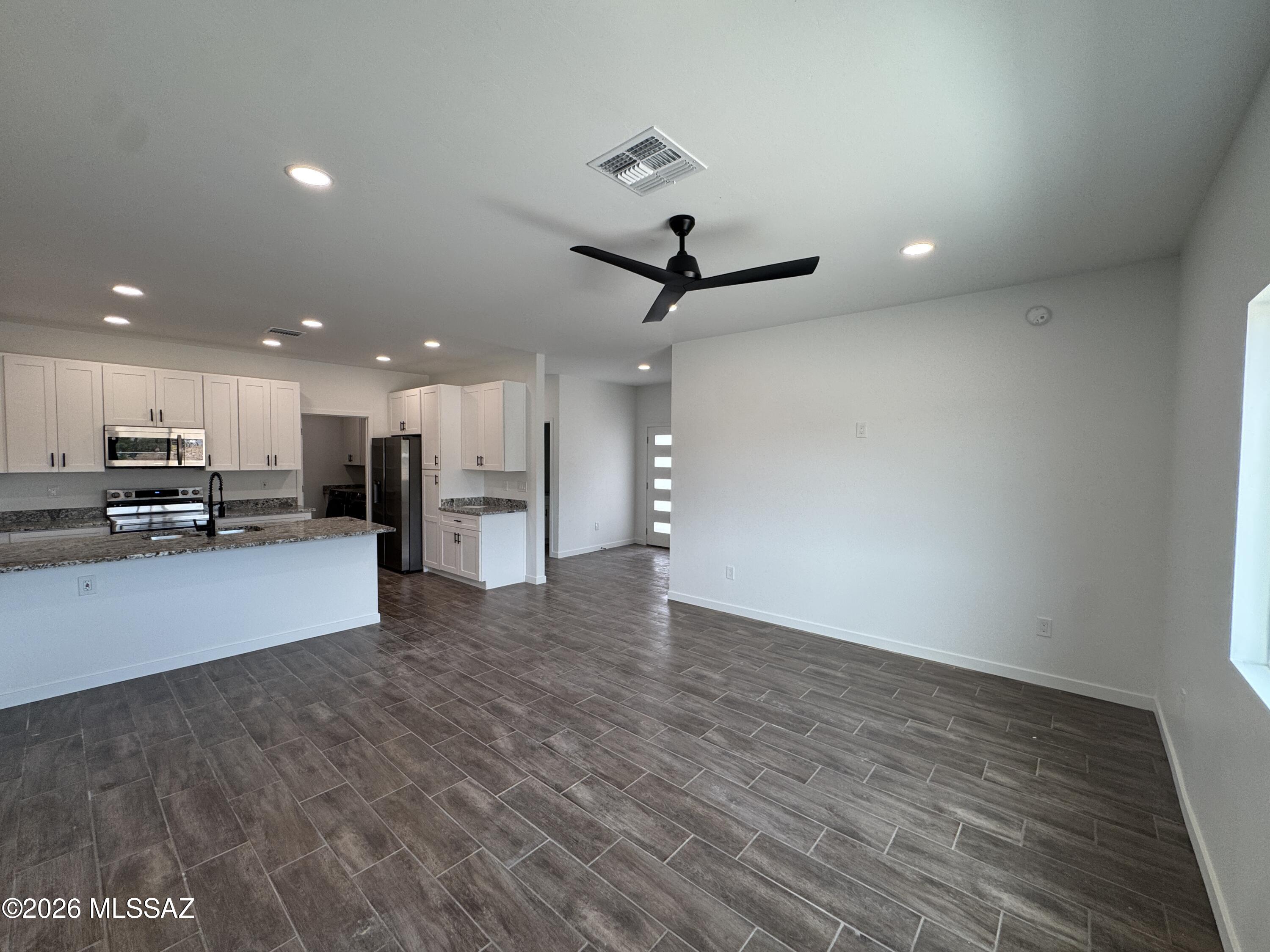 2122 North Ralph Avenue, Unit 1 Tucson, AZ 85712 - Photo 3 of 10 a view of an empty room with kitchen appliances