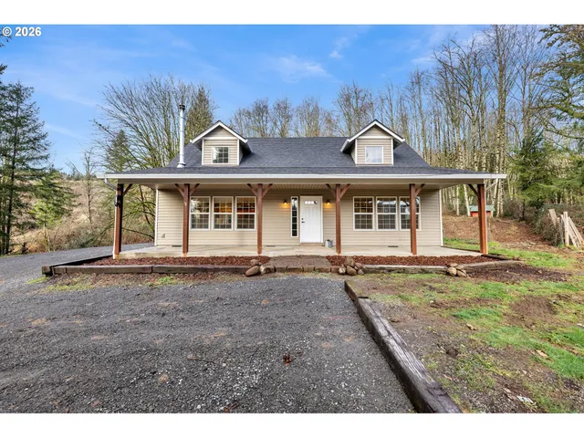 a view of a large house with a garden and yard