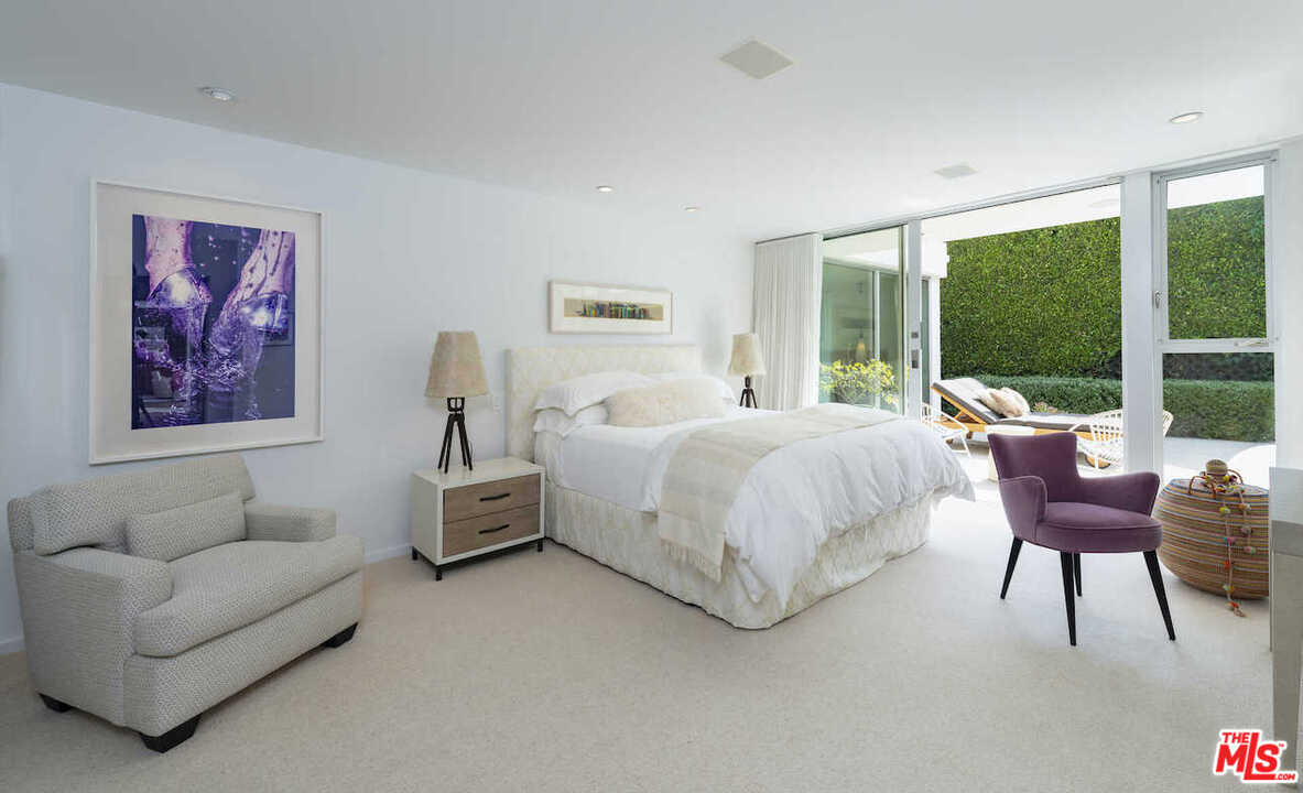 1566 Rising Glen Road Los Angeles, CA 90069 - Photo 16 of 32 a bedroom with furniture and a large window