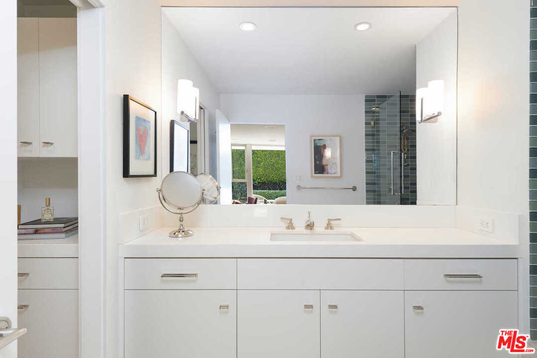 1566 Rising Glen Road Los Angeles, CA 90069 - Photo 17 of 32 a bathroom with a sink and a mirror