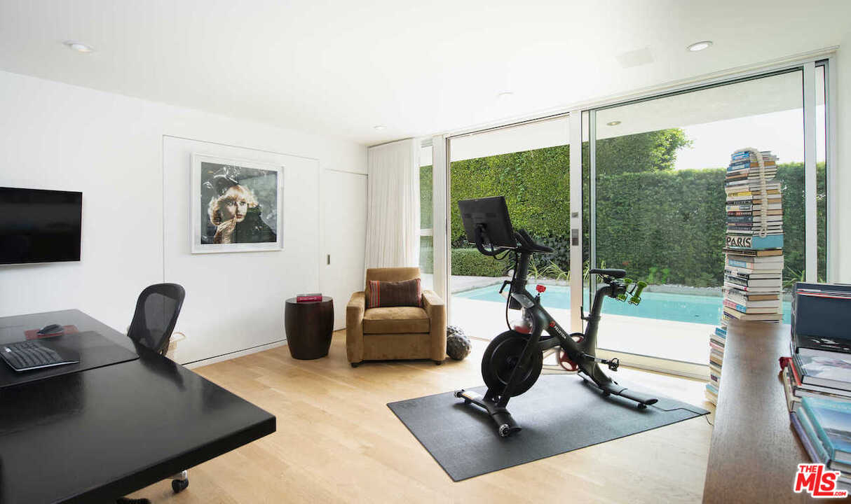 1566 Rising Glen Road Los Angeles, CA 90069 - Photo 18 of 32 a living room with furniture floor to ceiling window and a flat screen tv
