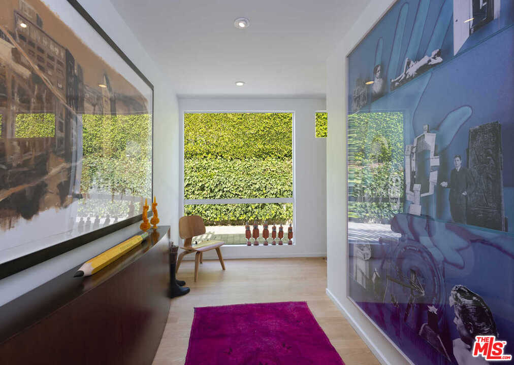 1566 Rising Glen Road Los Angeles, CA 90069 - Photo 19 of 32 a living room with furniture and a large window