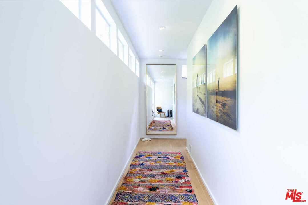 1566 Rising Glen Road Los Angeles, CA 90069 - Photo 20 of 32 a view of a hallway with wooden floor