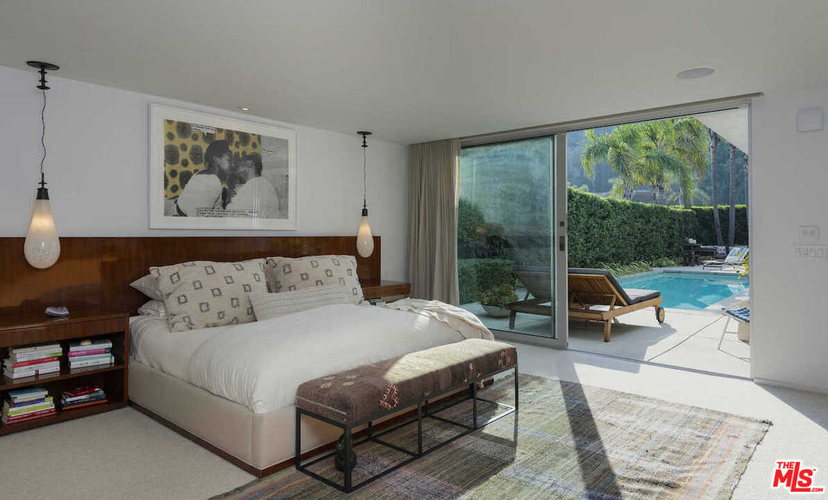 1566 Rising Glen Road Los Angeles, CA 90069 - Photo 22 of 32 a bedroom with a large bed and a large window