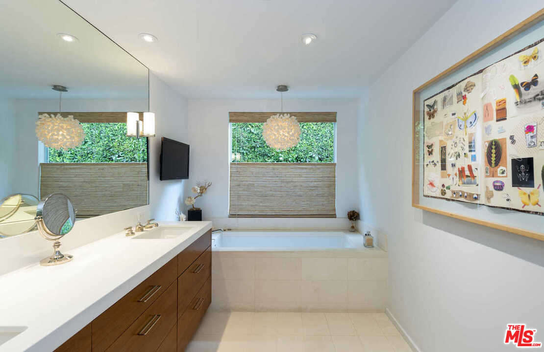1566 Rising Glen Road Los Angeles, CA 90069 - Photo 23 of 32 a bathroom with a tub sink and window