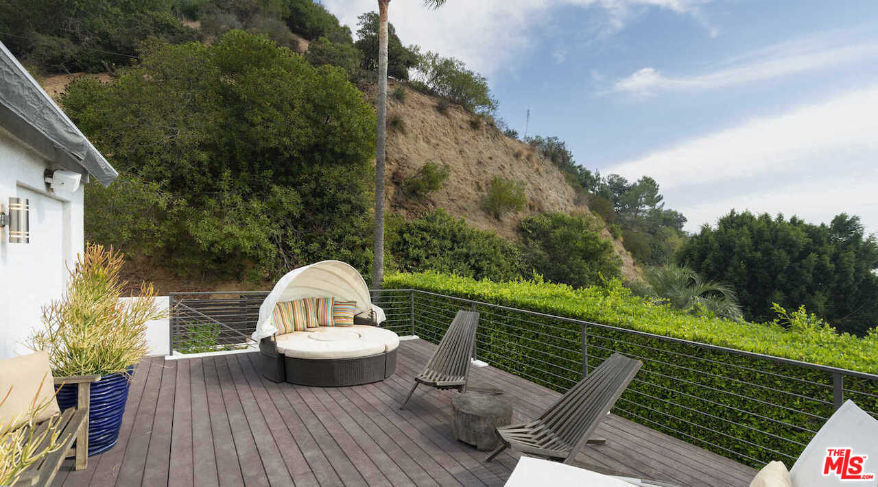 1566 Rising Glen Road Los Angeles, CA 90069 - Photo 28 of 32 a view of a wooden deck with furniture