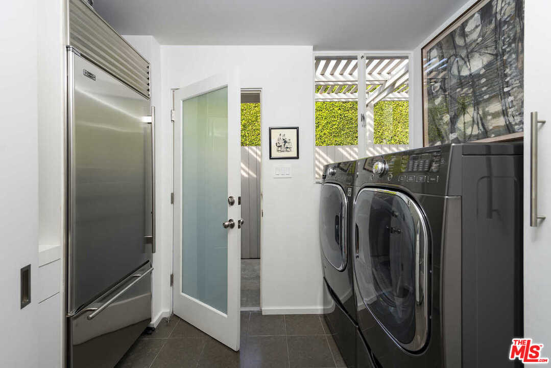 1566 Rising Glen Road Los Angeles, CA 90069 - Photo 29 of 32 a view of walk in closet with window and glass door