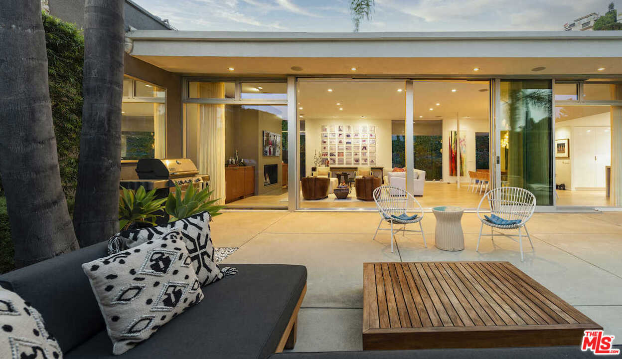 1566 Rising Glen Road Los Angeles, CA 90069 - Photo 4 of 32 a living room with furniture and a large window