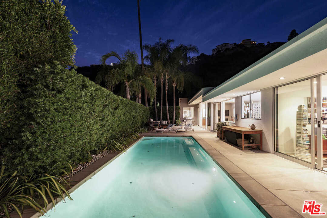 1566 Rising Glen Road Los Angeles, CA 90069 - Photo 32 of 32 a view of a house with swimming pool next to a yard