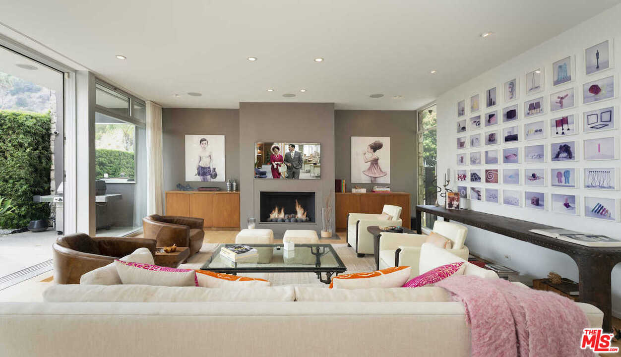 1566 Rising Glen Road Los Angeles, CA 90069 - Photo 8 of 32 a living room with furniture and a fireplace