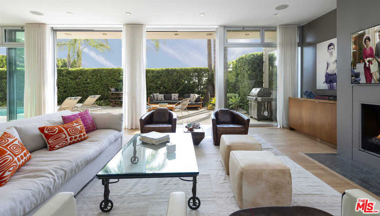 1566 Rising Glen Road Los Angeles, CA 90069 - Photo 10 of 32 a living room with furniture and a large window
