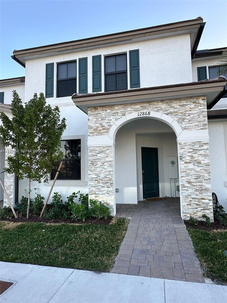 12868 Southwest 232nd Terrace Homestead, FL 33032 - Photo 1 of 48 front view of a house with a yard
