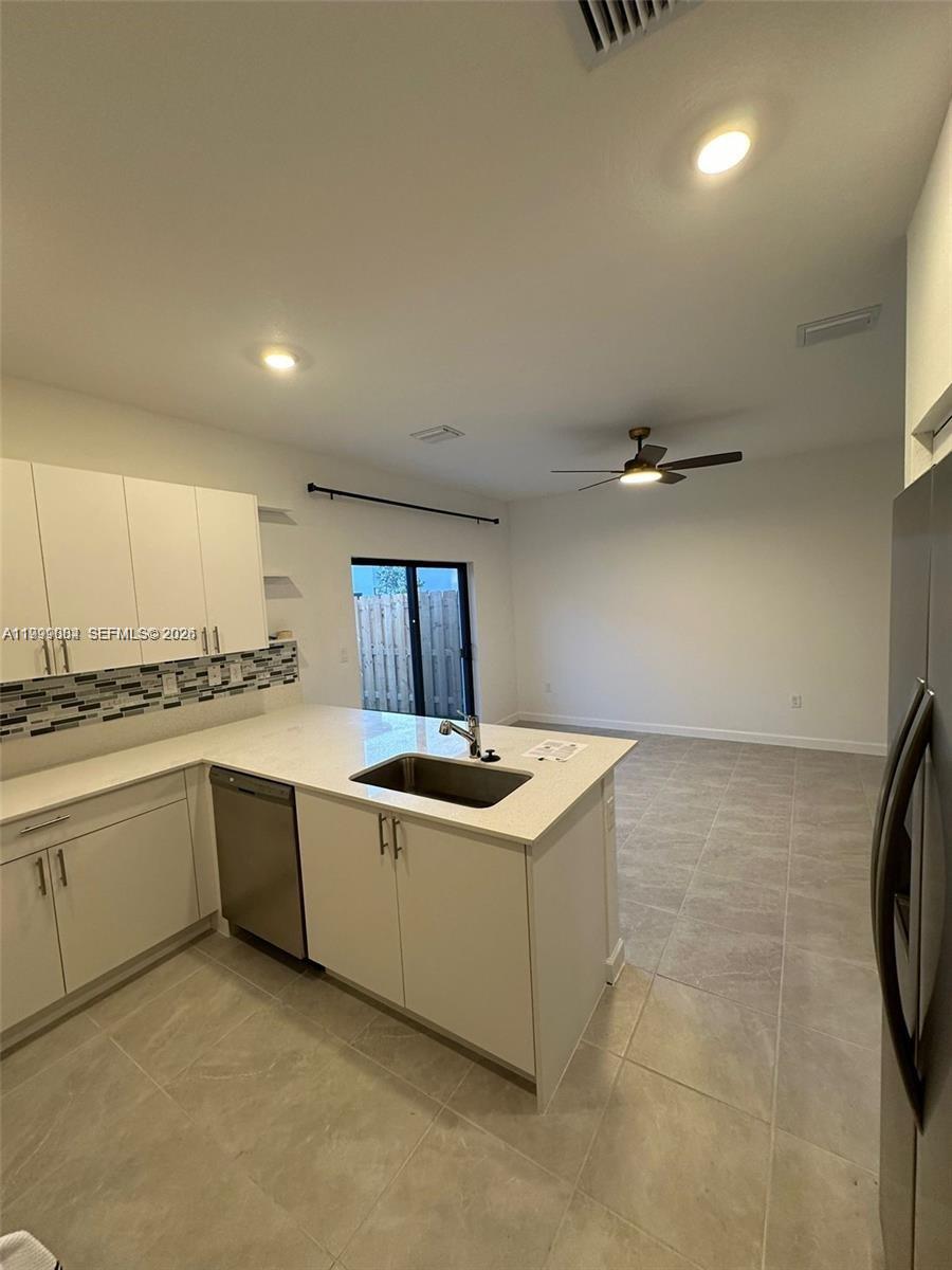 12868 Southwest 232nd Terrace Homestead, FL 33032 - Photo 16 of 48 a kitchen with stainless steel appliances granite countertop a sink and cabinets