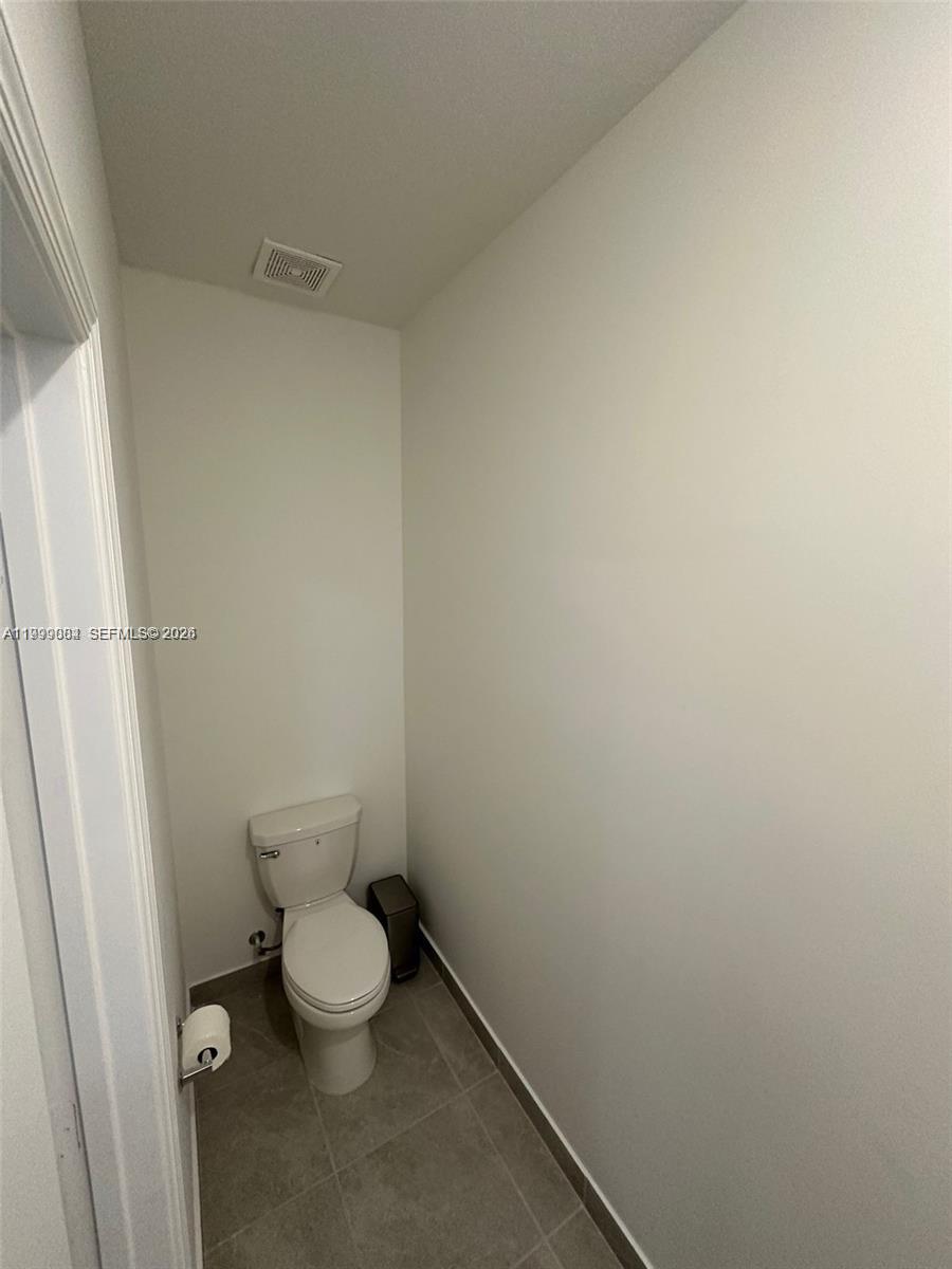 12868 Southwest 232nd Terrace Homestead, FL 33032 - Photo 17 of 48 a white toilet sitting next to a bathroom sink