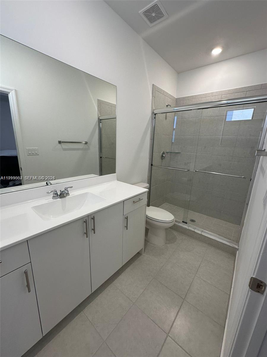 12868 Southwest 232nd Terrace Homestead, FL 33032 - Photo 18 of 48 a bathroom with a double vanity sink toilet and shower
