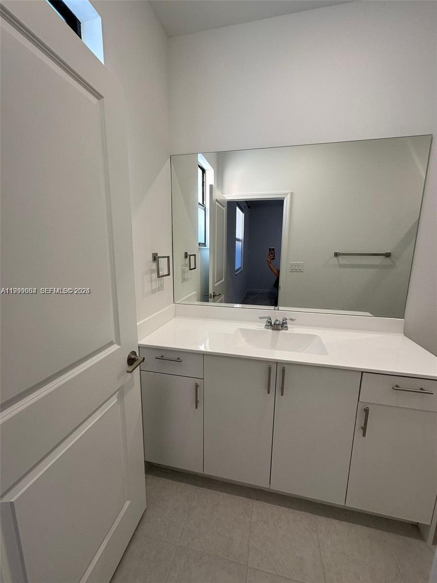 12868 Southwest 232nd Terrace Homestead, FL 33032 - Photo 20 of 48 a bathroom with a sink and a mirror