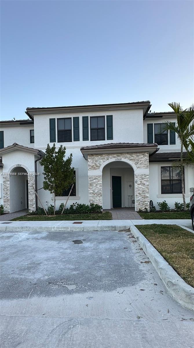 12868 Southwest 232nd Terrace Homestead, FL 33032 - Photo 2 of 48 a front view of a house with garden
