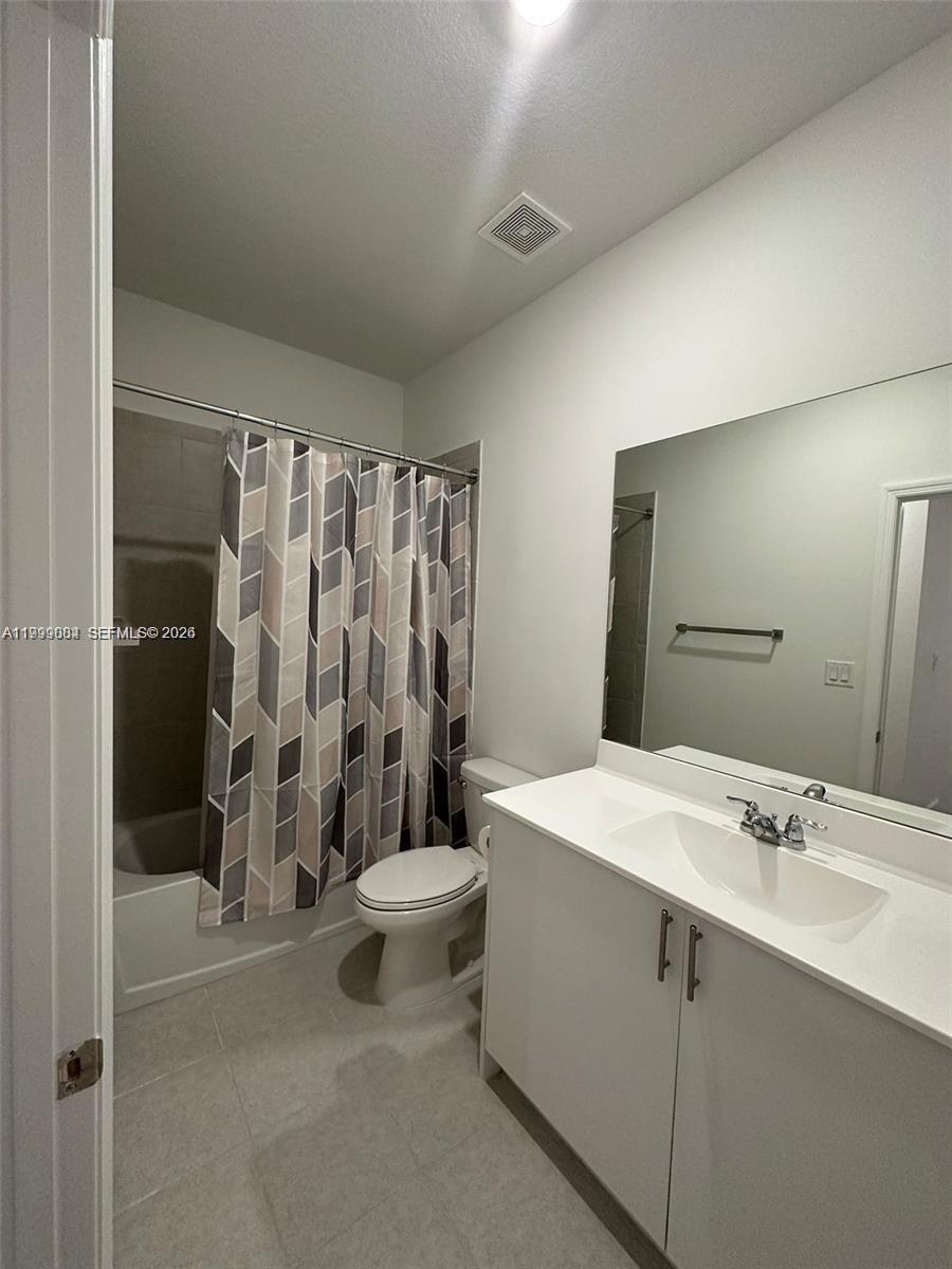 12868 Southwest 232nd Terrace Homestead, FL 33032 - Photo 22 of 48 a bathroom with a double vanity sink toilet and shower