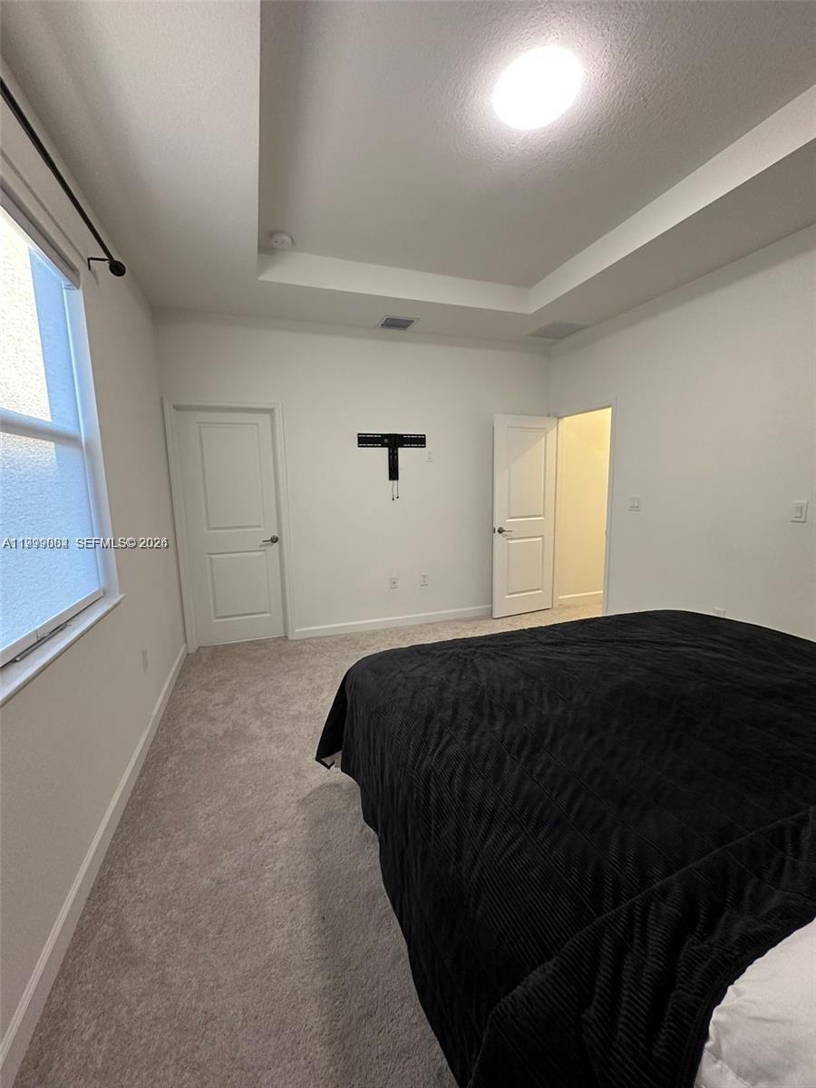 12868 Southwest 232nd Terrace Homestead, FL 33032 - Photo 27 of 48 a bedroom with a bed and a window