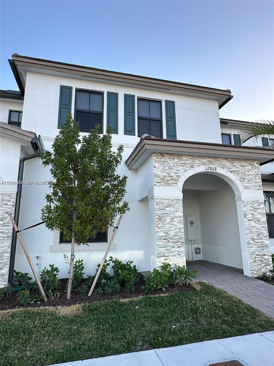 12868 Southwest 232nd Terrace Homestead, FL 33032 - Photo 3 of 48 a front view of a house with garden