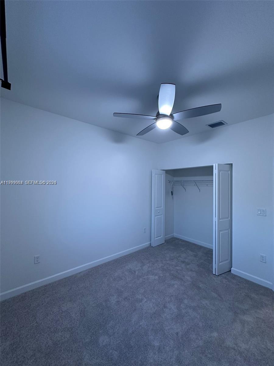 12868 Southwest 232nd Terrace Homestead, FL 33032 - Photo 38 of 48 a view of an empty room with a chandelier fan