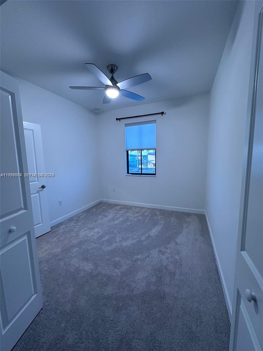 12868 Southwest 232nd Terrace Homestead, FL 33032 - Photo 39 of 48 en empty room with windows and fan