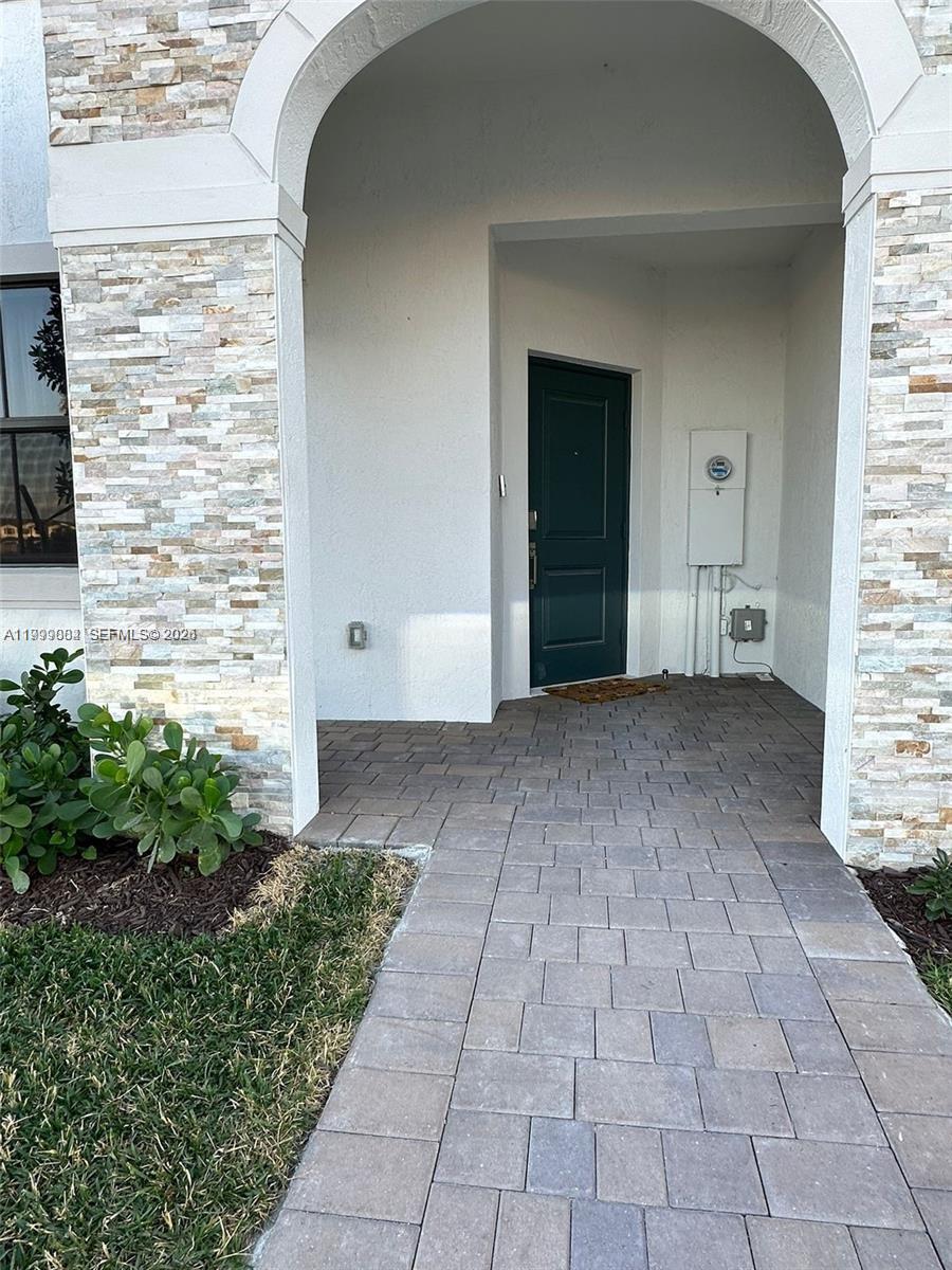 12868 Southwest 232nd Terrace Homestead, FL 33032 - Photo 4 of 48 a view of a front door of a house with a yard