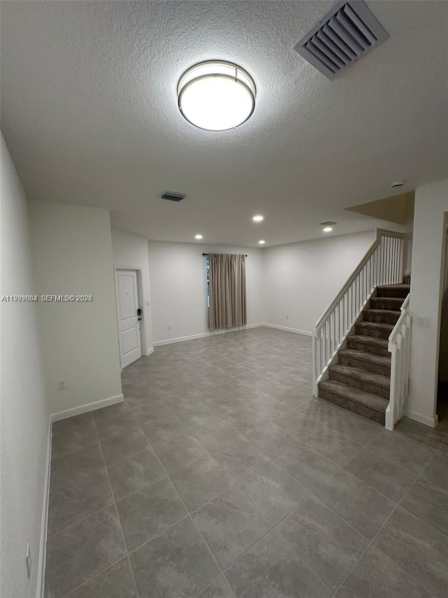 12868 Southwest 232nd Terrace Homestead, FL 33032 - Photo 9 of 48 an empty room with wooden floor and windows