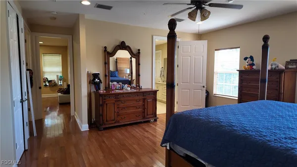 a bedroom with a bed and a dresser