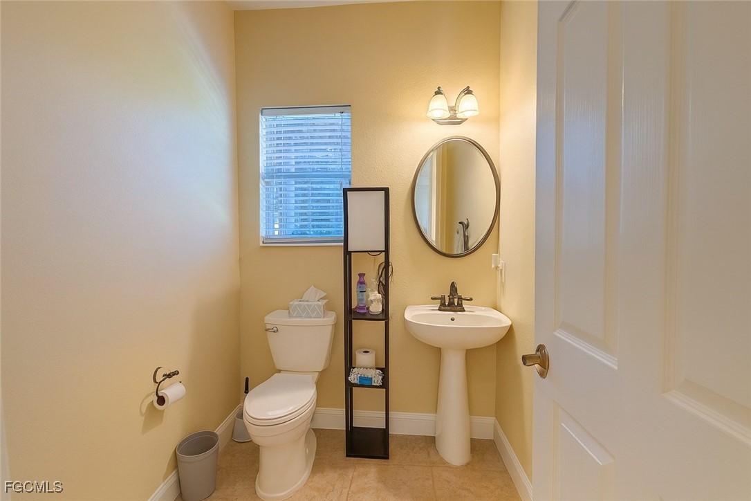 965 Stenstrom Road Wauchula, FL 33873 - Photo 22 of 25 a bathroom with a sink mirror and toilet