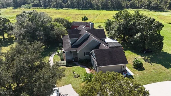 an aerial view of a house with a yard basket ball court and outdoor seating