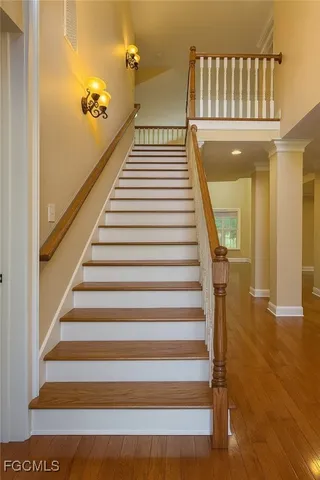 a view of entryway and hall with wooden floor